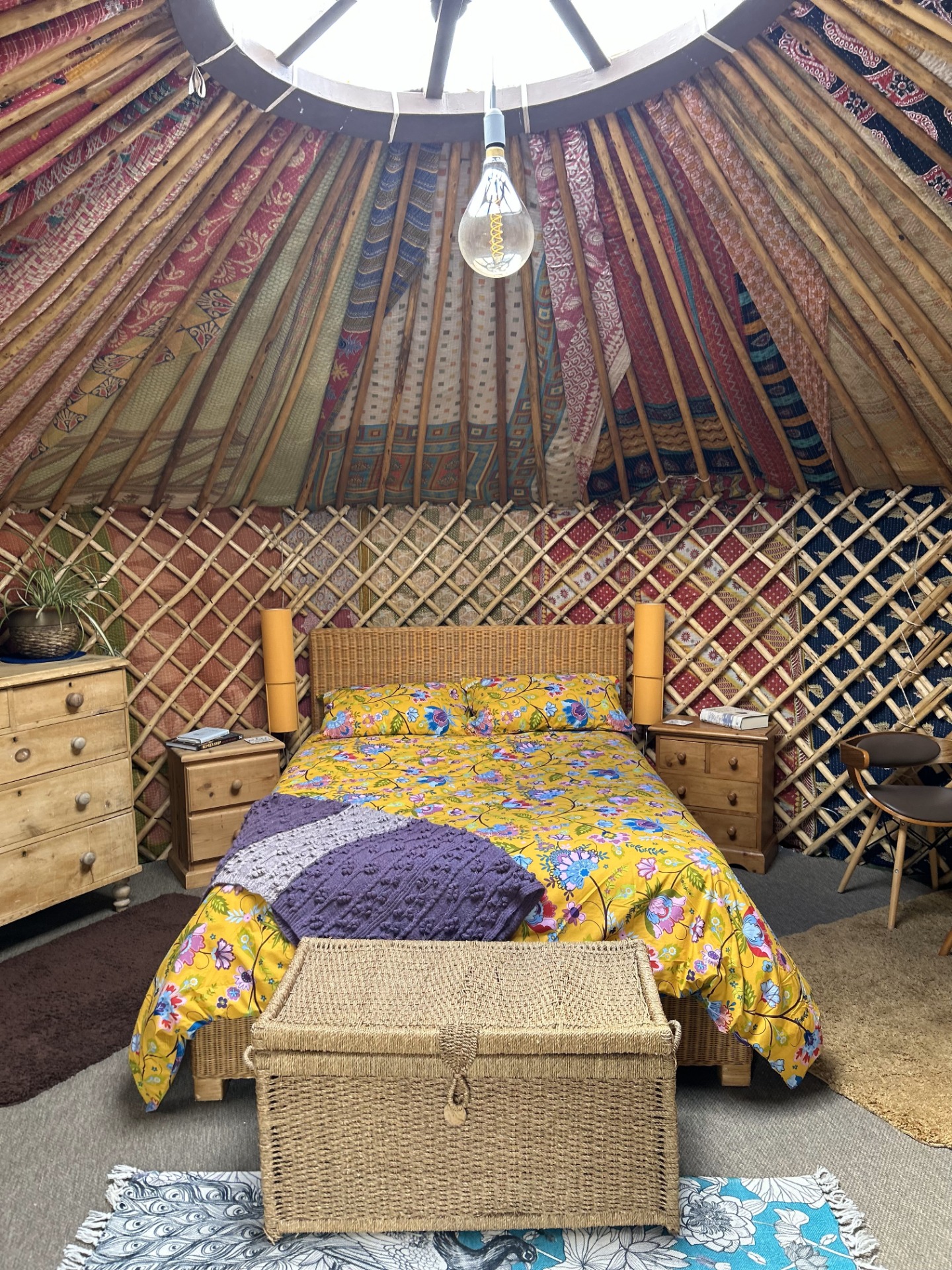 Primrose Yurt Cosy interior with double bed and electric lighting